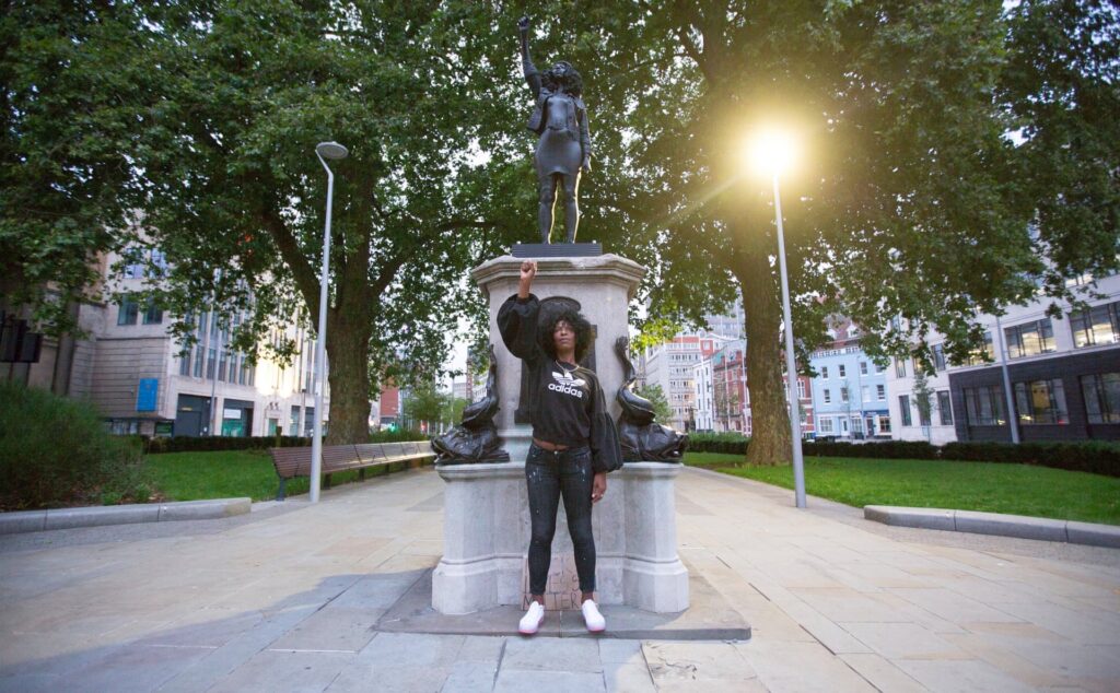 Jen Reid stands in front of a sculpture of herself erected in place of Edward Colston on 15 July 2020